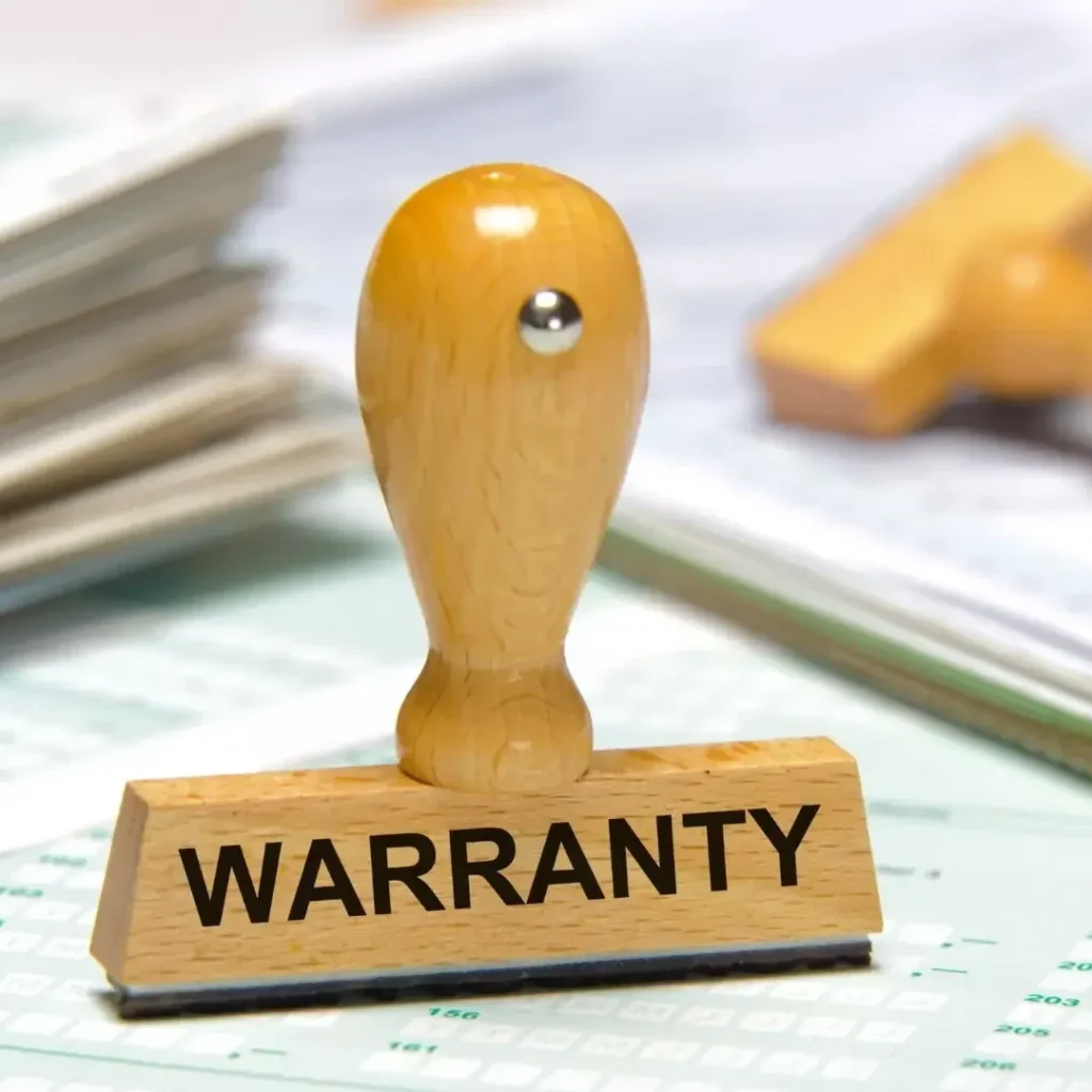 A wooden ‘warranty stamp’ resting on top of paperwork, symbolizing warranty coverage for an RV.