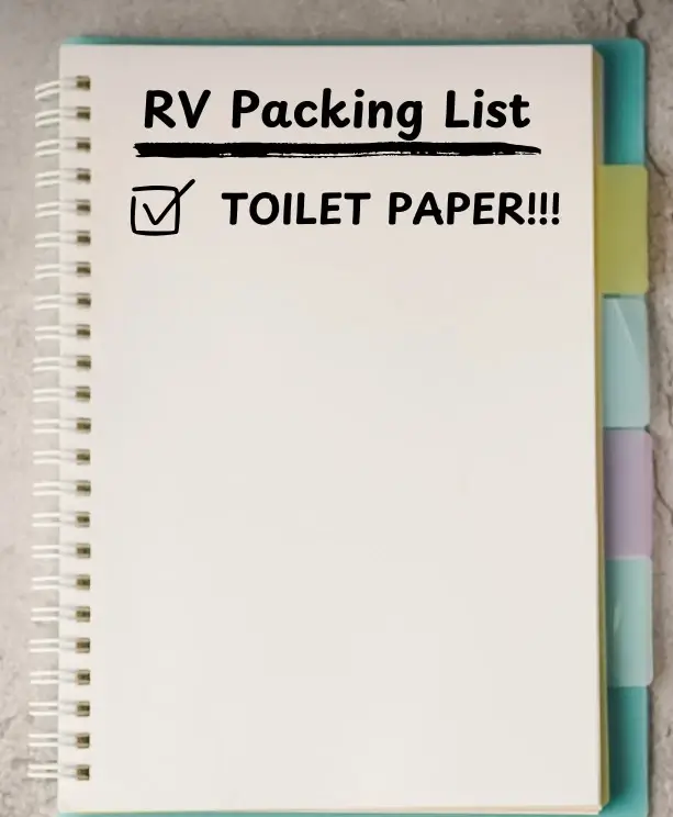 A notepad with a packing list for boondocking in an RV written on it and the item "Toilet Paper" checked off.