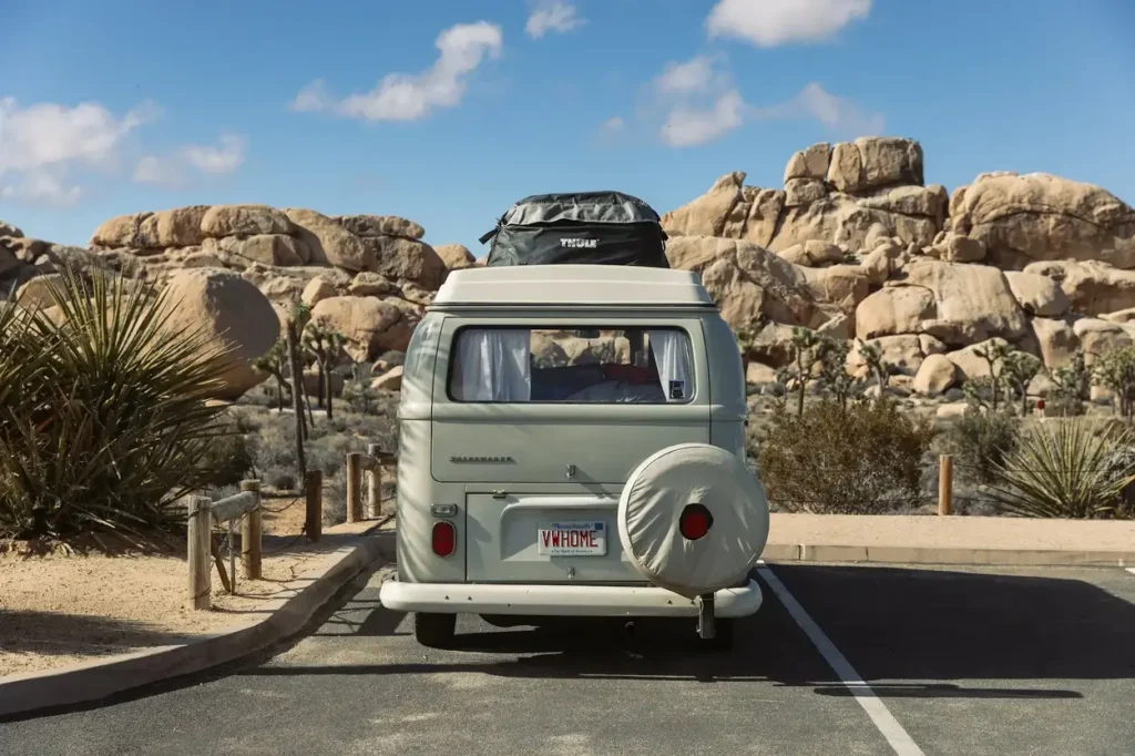 An old Volkswagen campervan parking lot camping in a more regional desert area.