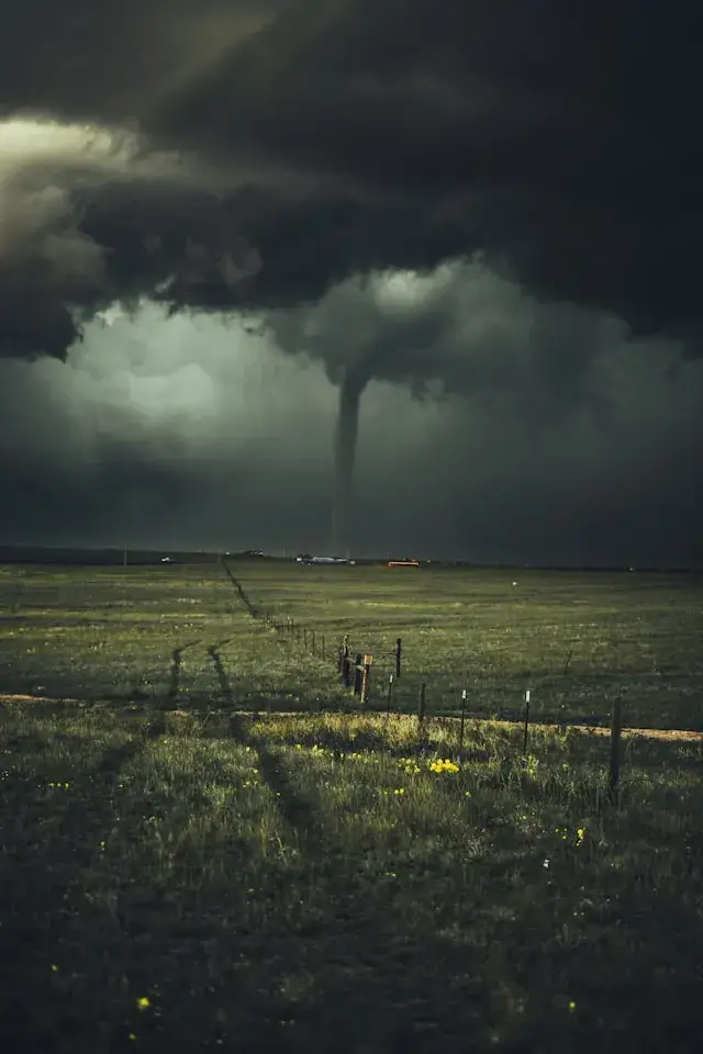 Inclement weather rolling into a not-so-safe dispersed camping site with black, stormy clouds and a small tornado on the horizon.