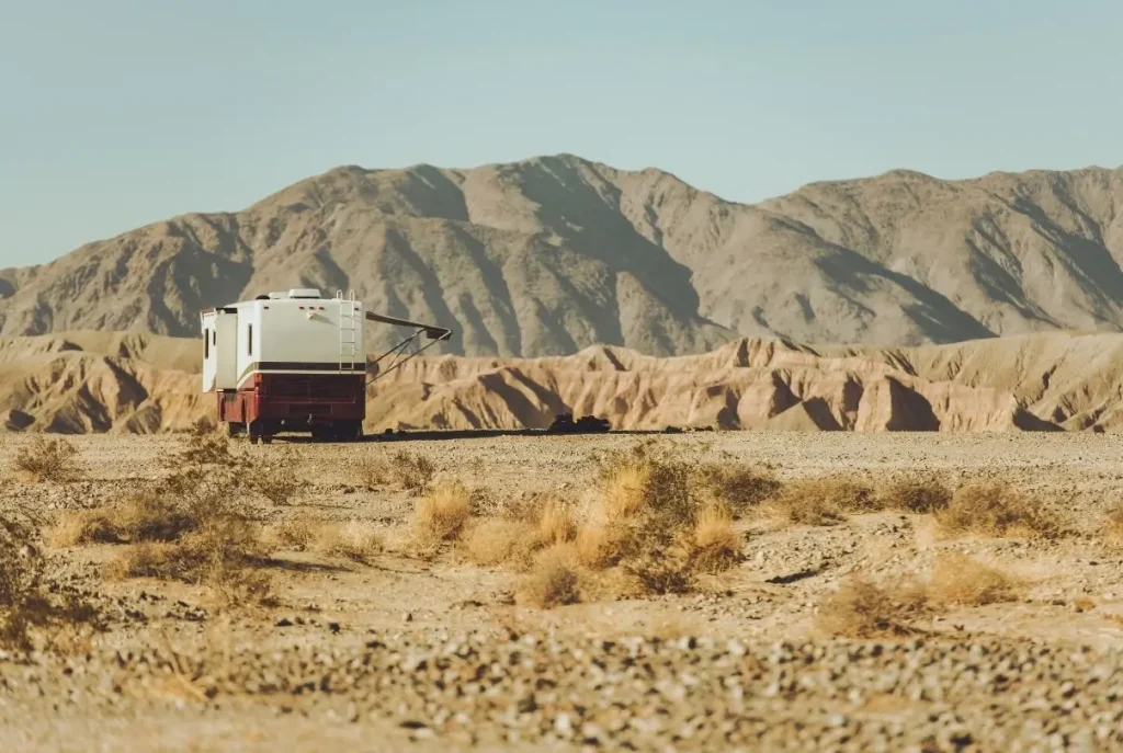 Someone living in an RV full-time, boondocking in a remote desert country in California.