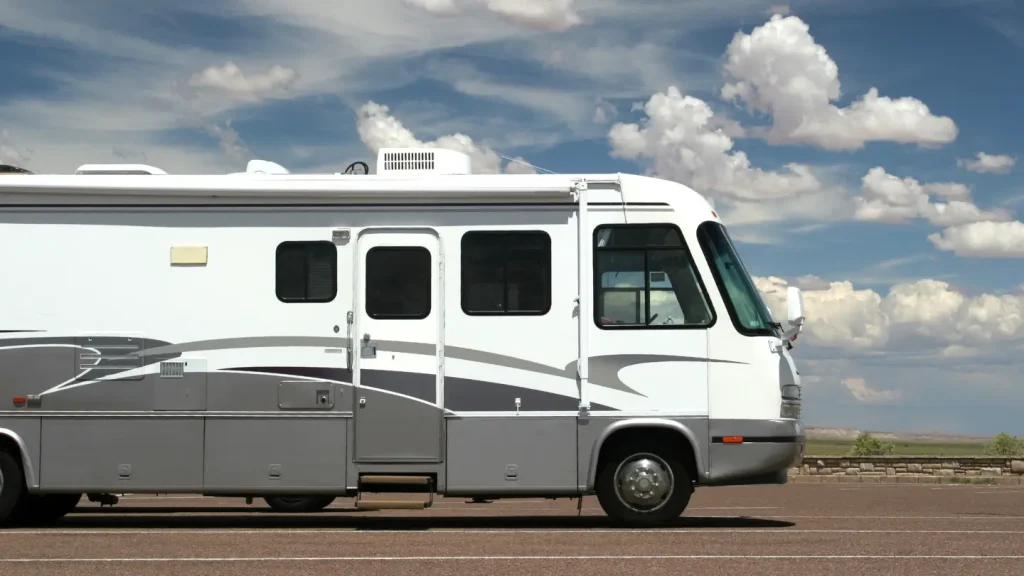 A Class A RV in a parking lot fully equipped for full-time RV residency.