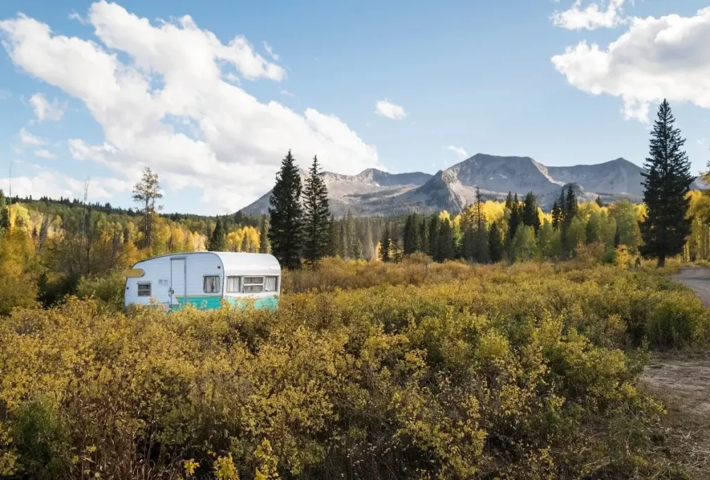 A caravan trailer set up on private property in a mountain landscape in Colarado.