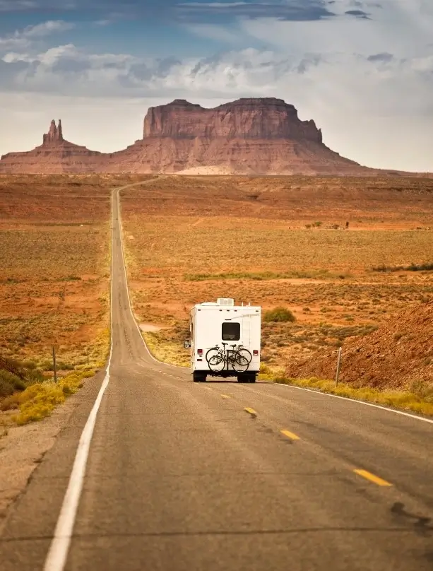 Someone enjoying the RV life in Arizona, driving down a scenic desert highway in a motorhome.