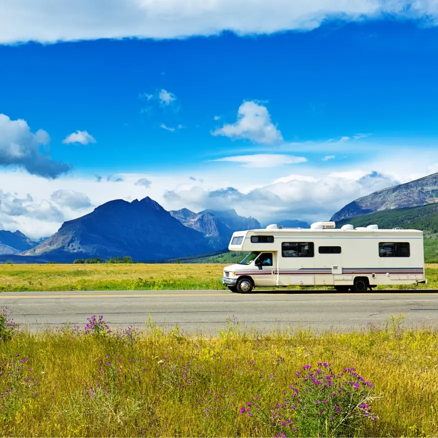 A Class A motorhome being driven by a full-timer living the RV life in Montana's natural wonder.