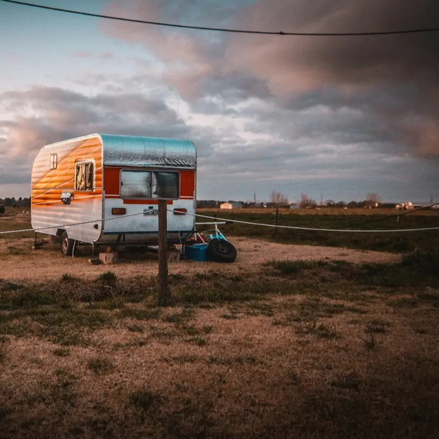A permanently set up travel trailer belonging to someone living in it full-time on their private rural land.
