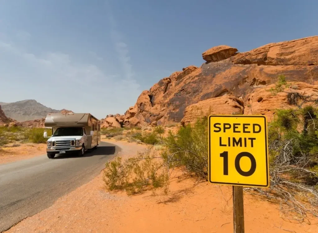 An RV driving down a low-speed off-road in the Valley of Fire National Park in Nevada.