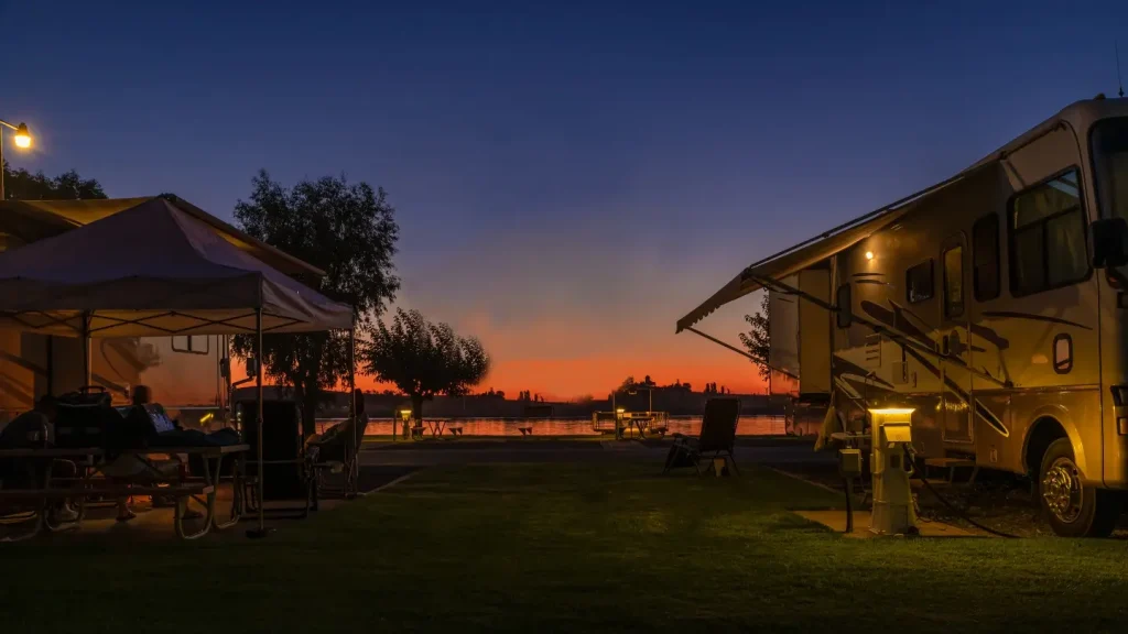 Several rigs camped in a lakeside budget RV park with full hookups and other great amenities in Rio Vista, California.