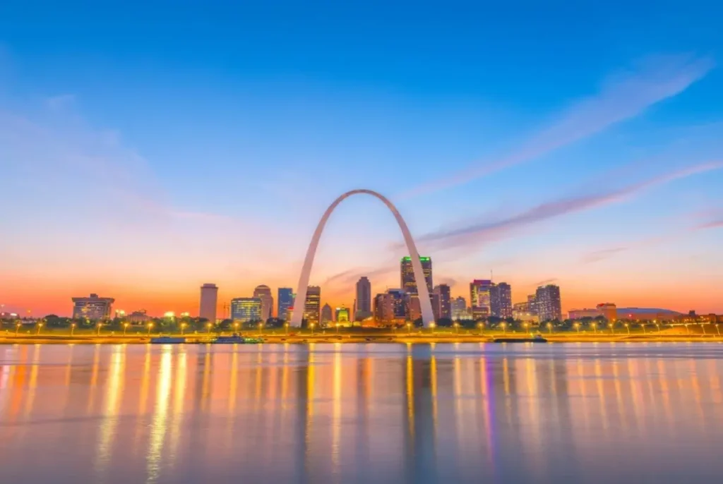 St. Louis's Gateway Arch and city skyline photographed at sunrise from on the water.