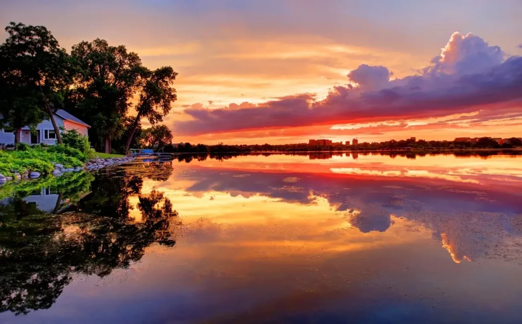 Lake Monona in Madison, Wisconsin, with a blazing sunset reflecting off the still water.