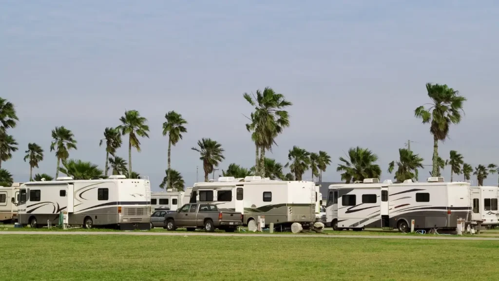 A group of motohome travelers all signed up to the best RV club, enjoying membership perks and camping together in a community near the beach.