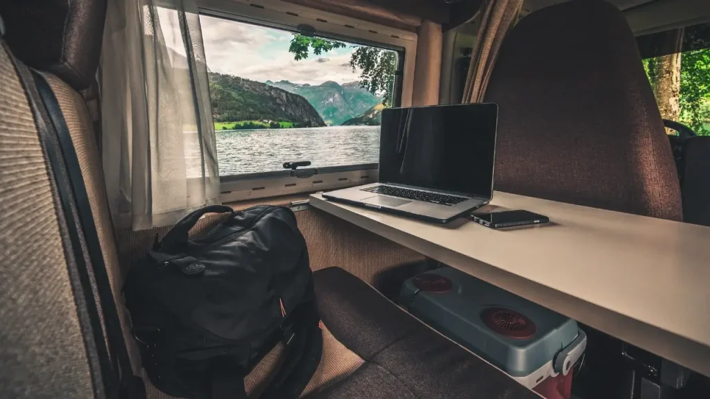 The motorhome office setup of a digital nomad camped in the mountains and utilizing one of the best RV internet options for connectivity.