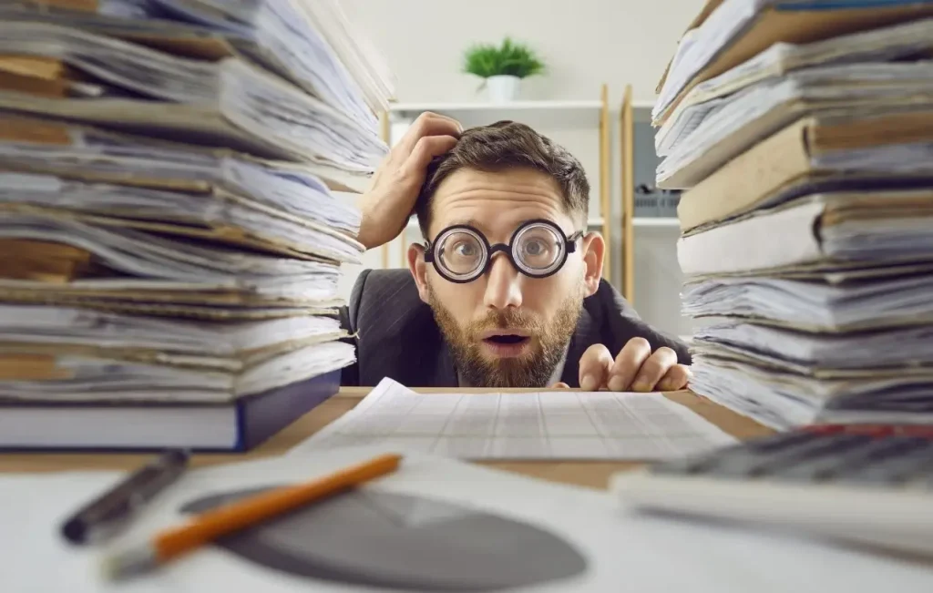 A confused customer examining a stack of paperwork, dissecting the fine print of his extended warranty policy.
