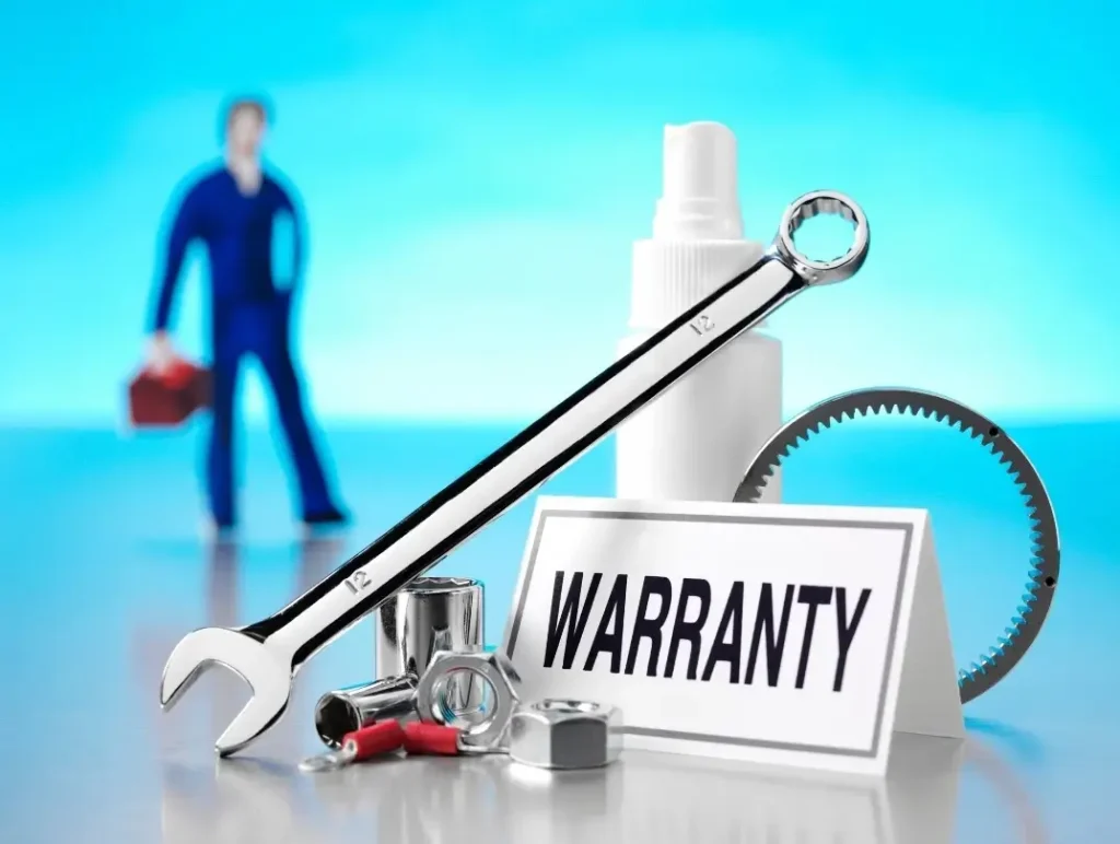 A sign that says "warranty" surrounded by tools and equipment with a blurry RV mechanic standing in the backgrounded.