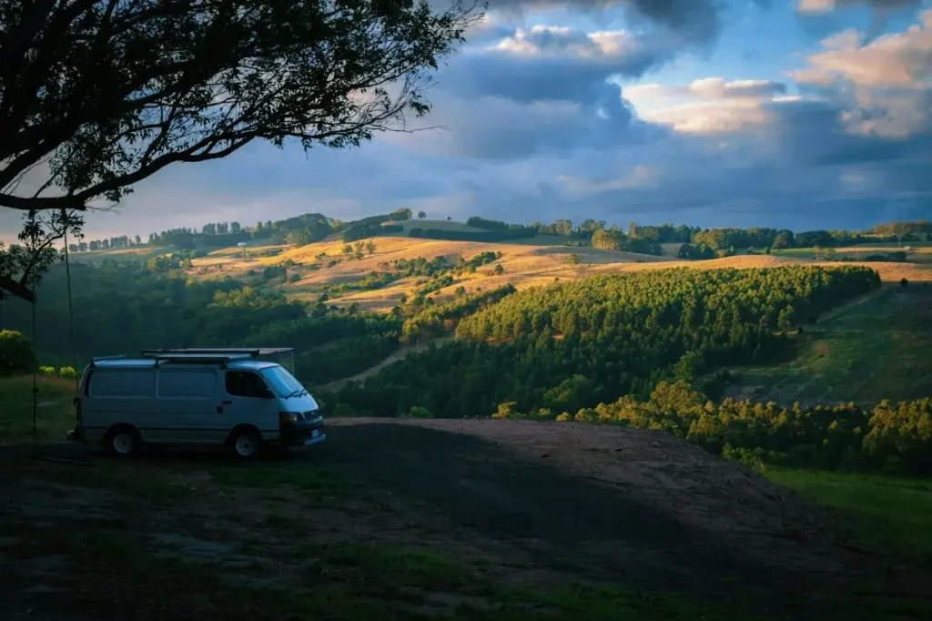 A Toyota Hiace camped at a beautiful rural location in Victoria, Australia, demosntrating the van model's wide usage outside of the USA.