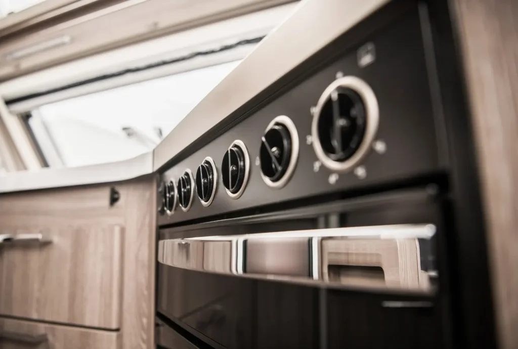 Modern RV kitchen equipped with a black premium-grade oven.