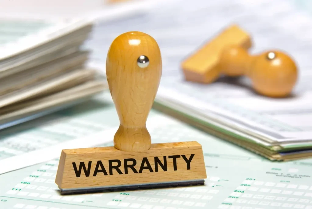 A wooden ‘warranty stamp’ resting on top of paperwork, symbolizing warranty coverage for an RV.